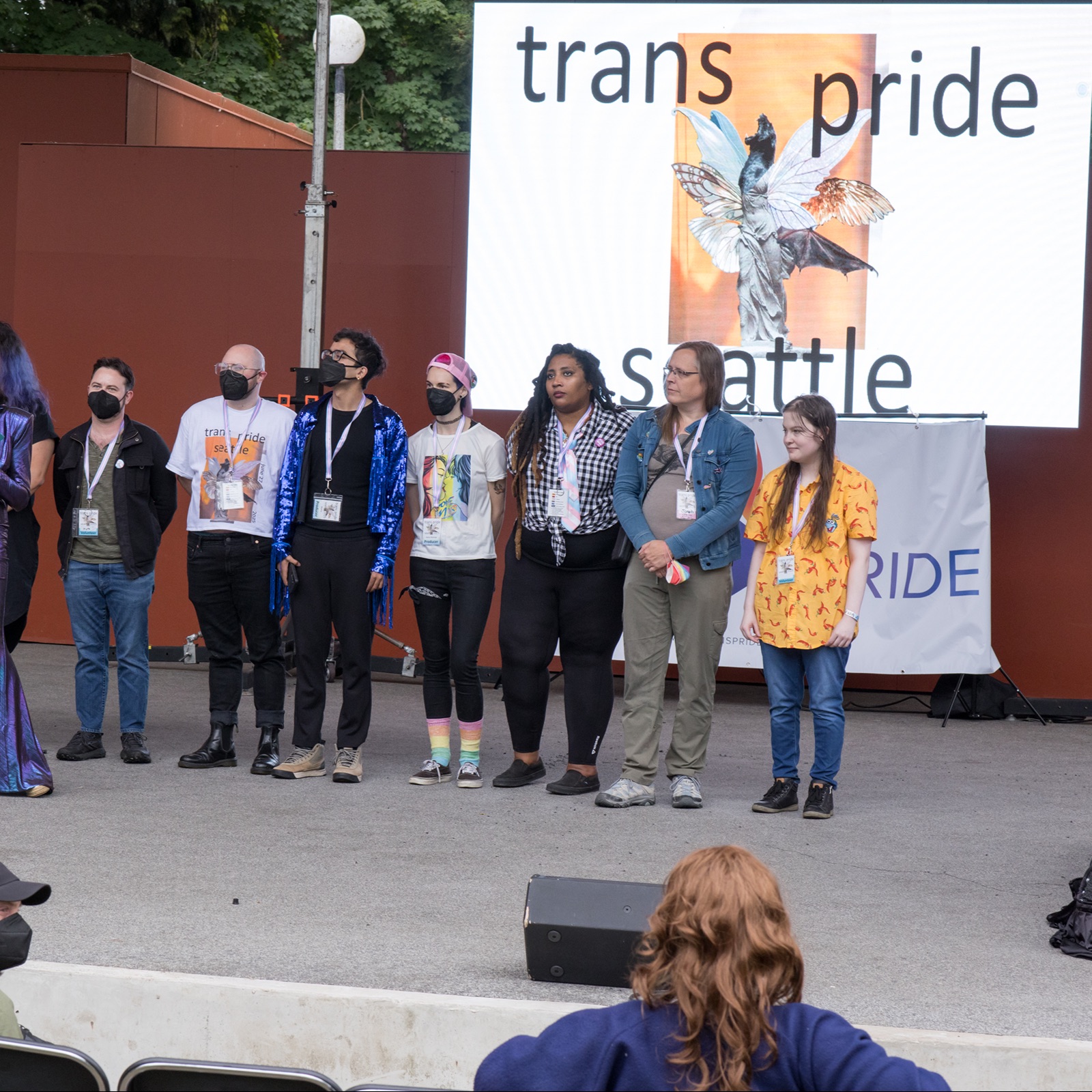 Danni speaking with GJL board and staff on stage at Trans Pride Seattle, 2025